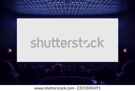 Cinema. White cinema screen with silhouettes of spectators in the hall.
