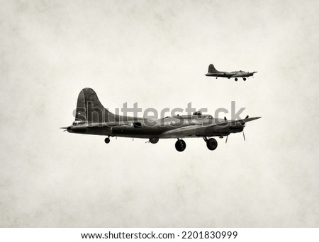 Two World War II bombers in flight on black and white stained background Royalty-Free Stock Photo #2201830999