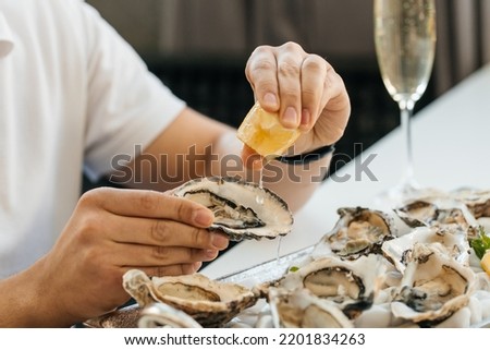 oyster. Man eating shellfish. Seafood and Mediterranean cuisine with mussels in shell. oyster in luxury restaurant. Royalty-Free Stock Photo #2201834263