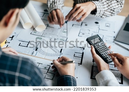 Close up of hands working brainstorming and measuring for cost estimating on paperworks and floor plan drawings about design architectural and engineering for houses and buildings. Royalty-Free Stock Photo #2201839353