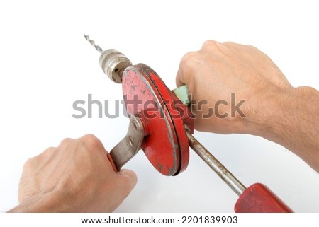manual mechanical drill in the hands of a master, on a white isolated background