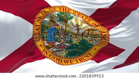 Close-up view of the Florida state flag waving. Florida is a state located in the Southeastern region of the United States. Fabric textured background