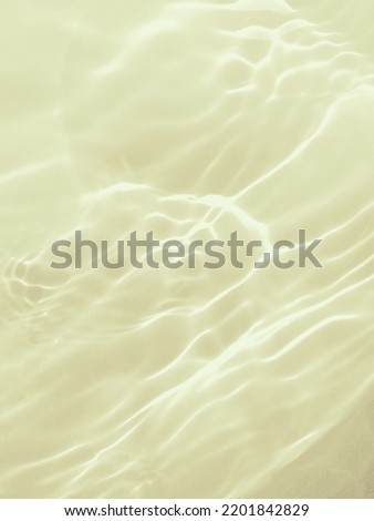 Closeup​ blur​ abstract​ of​ surface​ blue​ water. Abstract​ of​ surface​ blue​ water​ reflected​ with​ sunlight​ for​ background.Top​ view​ of blue​ water.​ Water​ splashed​ use​ for​ art​ print.