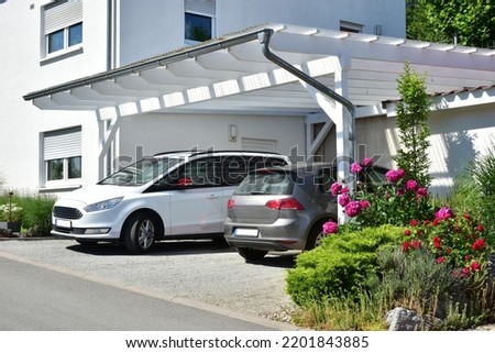 New wooden Carport in Front of a Residential Building Royalty-Free Stock Photo #2201843885