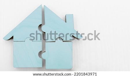 pieces of blue wooden house puzzle isolated on white  background. wooden home made from natural material of jigsaw. puzzle in the form of wood house. for sale or rent. concept of mortgage