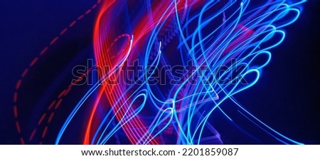 Blue and red light painting photography, long exposure fairy blue and red lights curves and waves against a black background. Long exposure light painting photography. Abstract pink purple swirls
 Royalty-Free Stock Photo #2201859087