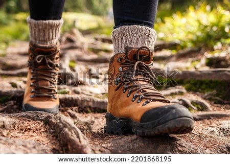 Hiking boot. Legs on mountain trail during trekking in forest. Leather ankle shoes Royalty-Free Stock Photo #2201868195