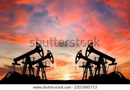 Crude oil Pumpjack on sunset. Fossil crude output and fuels oil production. Oil drill rig and drilling derrick. Global crude oil Prices, energy, petroleum demand (OPEC+). Pump jack at oilfield. Royalty-Free Stock Photo #2201880713
