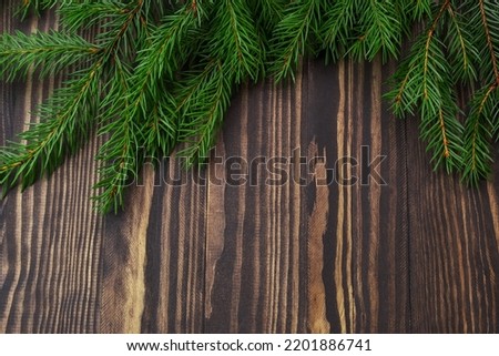 branches of spruce and pine on a wooden brown background with a place for the text mockup, the concept of the new year