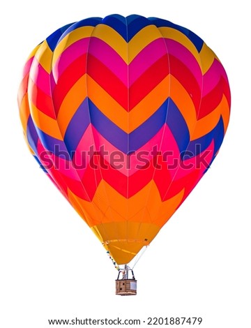 Orange and blue colorful and bright Ultramagic hot air balloon with chevron fabric pattern in flight isolated on white background for easy compositing.