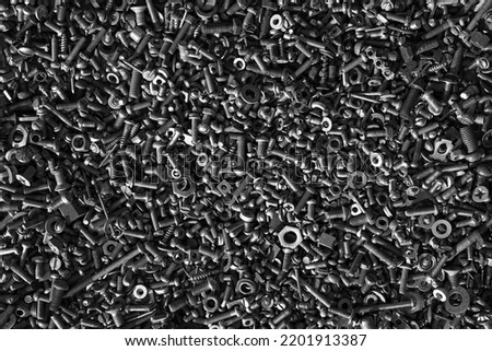 Metal steel gray bolts, nuts, screws and screws are lying on the floor. Fasteners and hardware for repair Royalty-Free Stock Photo #2201913387