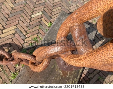 A hanging heavy rusty metal chain