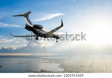 Private jet flying over Limassol city, Cyprus Royalty-Free Stock Photo #2201915429