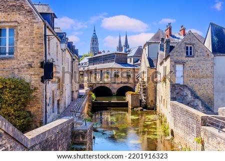 Bayeux, Normandy in northwestern France. The historic centre, the Notre Dame Cathedral and the Aure river. Royalty-Free Stock Photo #2201916323
