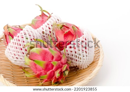 dragon fruit on a bamboo sieve on white background