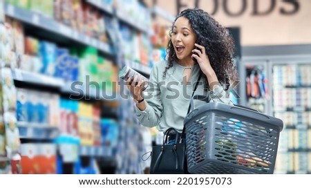 Supermarket, grocery shopping and surprise of a black woman on a phone call at a retail store. Wow, happy and omg facial expression of a customer hearing deal, price sale on stock and discount food Royalty-Free Stock Photo #2201957073