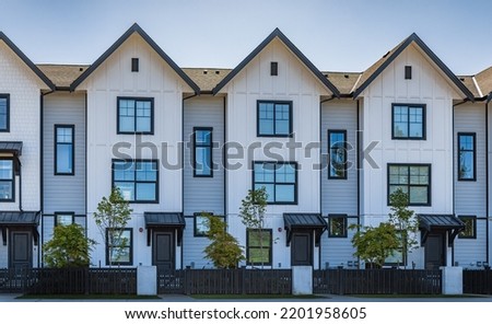 Brand new apartment building on sunny day in BC, Canada. Canadian modern residential architecture. Nobody, street photo Royalty-Free Stock Photo #2201958605