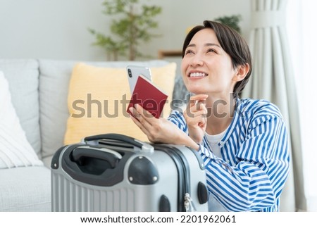 Middle woman preparing for travel Royalty-Free Stock Photo #2201962061