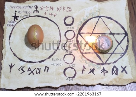 Ritual to remove curses using eggs On a piece of paper the wizard's insignia The runes in the picture represent the spells used in this ritual. This image is suitable for an article about magic.