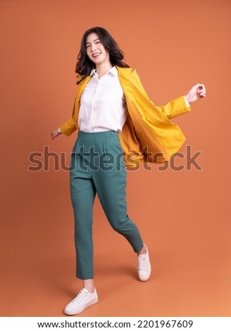 Full length photo of young Asian woman on background Royalty-Free Stock Photo #2201967609