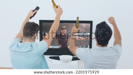 Composition of two male sports fans watching football match on tv. sport and competition concept digitally generated image.