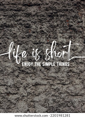 Motivational quote "life is short enjoy the simple things" in wall concrete background
