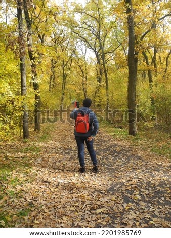  a girl goes in for sports in the forest and poses for a photographer at a photo shoot