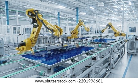 Large Production Line with Industrial Robot Arms at Modern Bright Factory. Solar Panels are being Assembled on Conveyor. Automated Manufacturing Facility Royalty-Free Stock Photo #2201996681