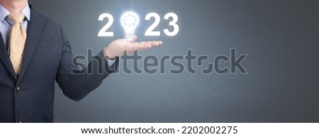 Business and Technology target set goals and achievement in 2023 new year resolution, planning and start up strategies and ideas. New year 2023 concept, hand holding 2023 virtual screen. copy space
