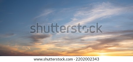 Panoramic beautiful colorful golden hour twilight sky. Beautiful cloud and sky nature background in magic hour. Amazing colorful sky and dramatic sunset evening sky. Royalty-Free Stock Photo #2202002343
