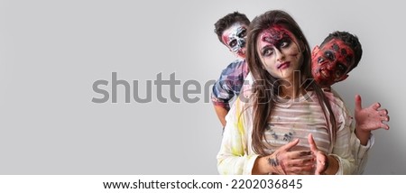 Scary zombies on grey background with space for text Royalty-Free Stock Photo #2202036845