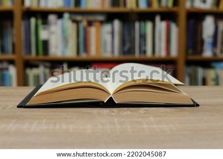 Open book on the table in library Royalty-Free Stock Photo #2202045087