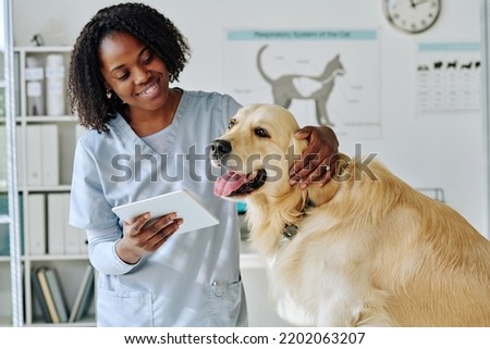 Young vet using tablet pc at her work Royalty-Free Stock Photo #2202063207