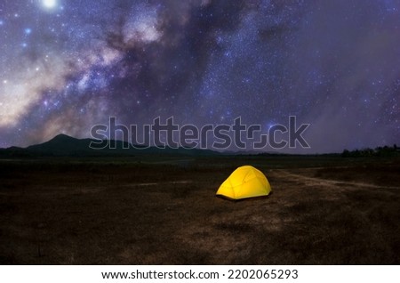 Yellow tent under Milky Way Galaxy Lampang Thailand, Universe galaxy milky way time lapse, dark milky way, galaxy view, star lines, timelapse night sky stars on sky background. 