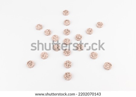 Heap of pink pills or vitamine tablets on a white background