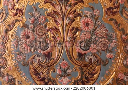 detail of 18th century rococo style gilt leather wall covering with floral pattern  Royalty-Free Stock Photo #2202086801
