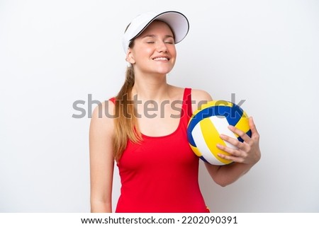 Young caucasian woman playing volleyball isolated on white background laughing