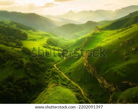 View of the green mountains and hills at sunset. Beautiful summer landscape. Aktoprak Pass in North Caucasus, Russia.  Royalty-Free Stock Photo #2202091397