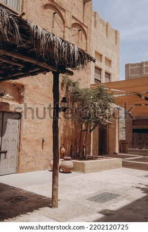 Architecture in heritage city representing old city at Al seef, Middle East, United Arab Emirates. Historic district in Dubai Creek neighborhood is a popular tourist place, traditional old arabic town Royalty-Free Stock Photo #2202120725