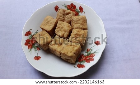 Delicious tahu kulit or tofu on plate. Indonesian local food made from soybean. Isolated on white background