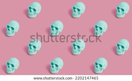 Seamless pattern of mint skulls on a pink background. Creepy concept. Halloween or Santa Muerte idea.