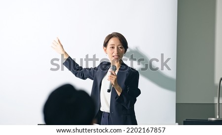 Asian businesswoman taking the stage at the seminar. Presentation.  Royalty-Free Stock Photo #2202167857