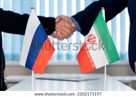 Political flags of russia and iran on table in international negotiation room. concept of negotiations, collaboration and cooperation of countries. agreement between the governments. Royalty-Free Stock Photo #2202173197