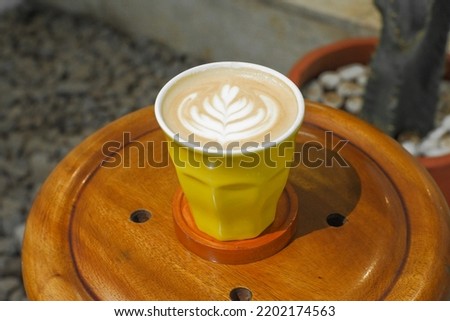 a cup of espresso coffee with a picture of a flower