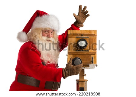 Santa Claus taking picture with old wooden camera