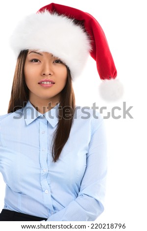 Christmas woman posing. Young smiling woman with red santa hat. Image of beautiful young Asian model isolated on perfect white background.