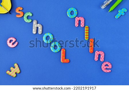 the inscription school online from the letters of the children's alphabet on blue background