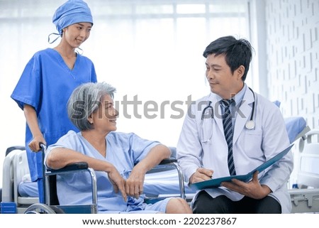 asian doctor with stethoscope and document folder, examine the symptom for senior patient in the recovery room. Healthcare and medicine concept.