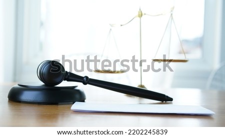 Lawyer or judge's hammer in the court. Auction's hammer is on woo table. Law subject. Judgement subject to judge people.