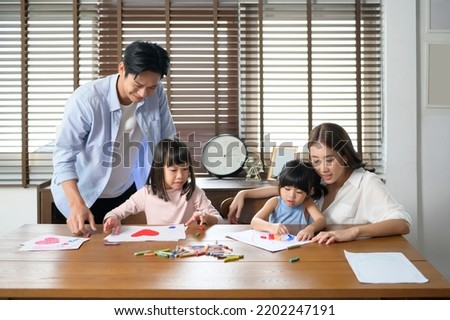 An Asian family with children Drawing and painting on table in playing room at home, Educational game.